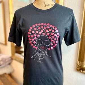 Black shirt with rose hair, sunglasses, red lips & bling scarf around neck.